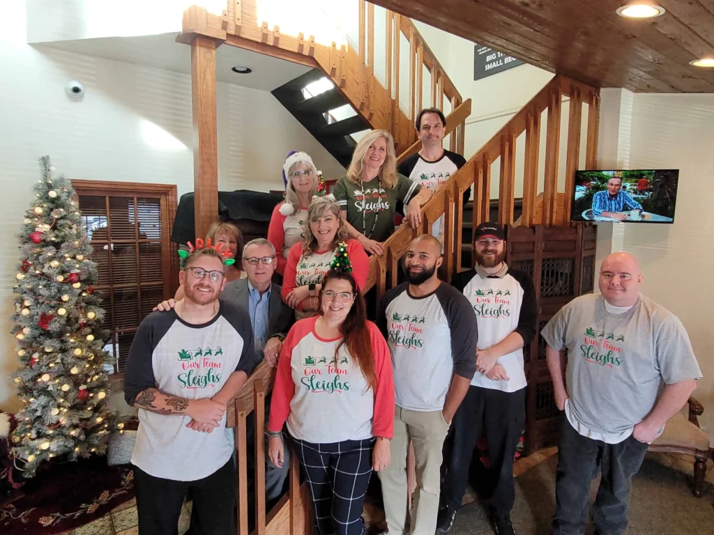 Team of employees at Card Systems posing together in a professional setting, showcasing their expertise in payment processing solutions.