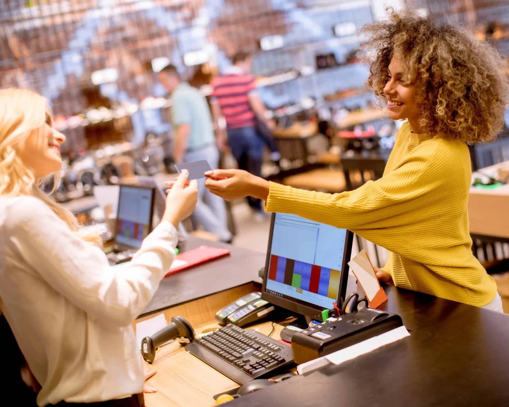Smiling customer making a purchase at a Florida retail store using Buy Now, Pay Later through Card Systems.