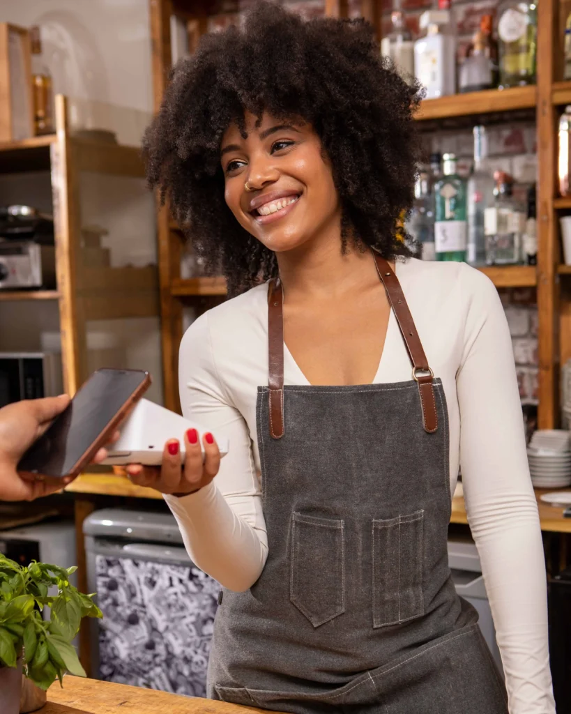 Shop owner in Florida accepting a mobile Buy Now, Pay Later payment from a customer using Card Systems.