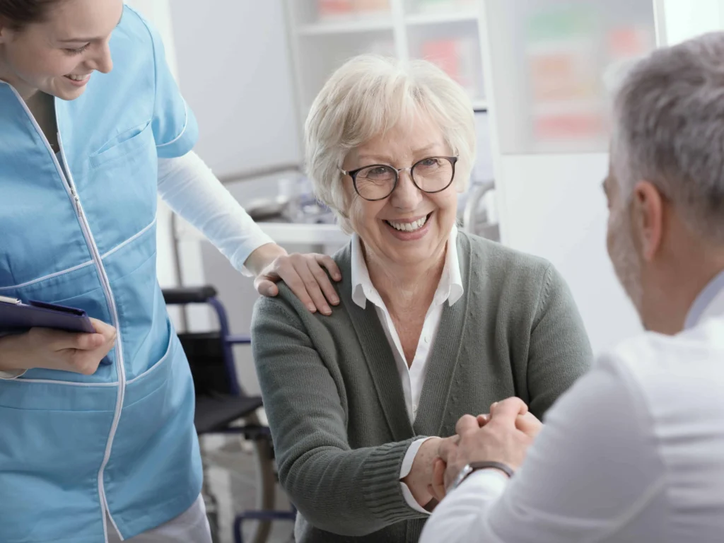 Smiling patient meeting with doctor and nurse in a Florida medical office discussing affordable patient financing options.