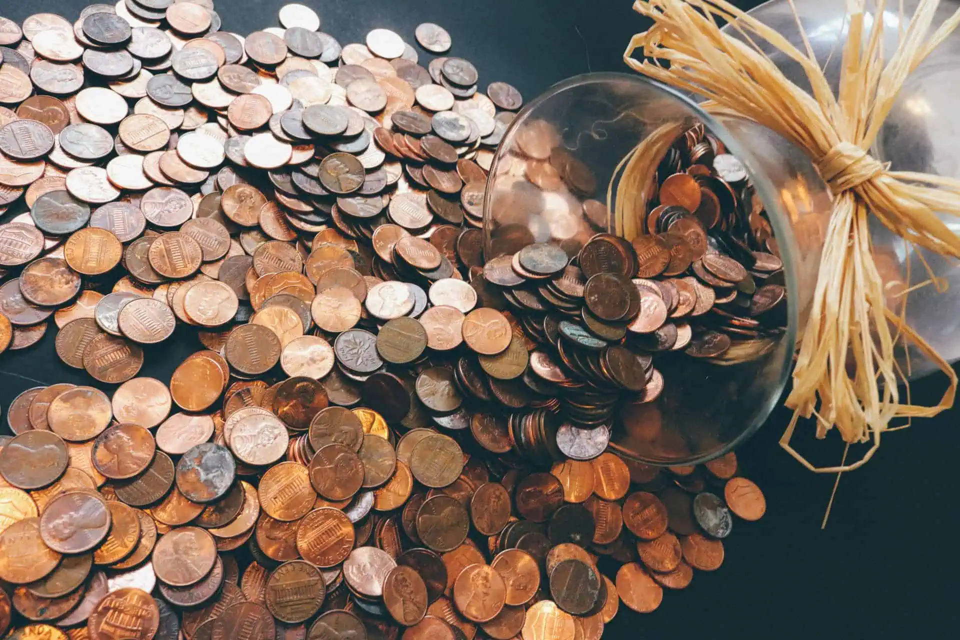 Pennies spilling from a jar, illustrating Florida’s cash rounding law